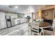 Modern kitchen featuring sleek countertops, white cabinetry, stainless appliances and dining area at 2397 E Winchester Pl, Chandler, AZ 85286