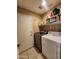 Laundry room with washer, dryer, and built-in shelving at 2397 E Winchester Pl, Chandler, AZ 85286