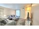 Comfortable living room with plush gray sofas, carpeted floor and large TV with bright, airy lighting at 2397 E Winchester Pl, Chandler, AZ 85286