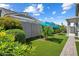 A beautiful backyard featuring green synthetic grass, garden, privacy wall, and well-placed shrubbery at 2644 S Dock St, Gilbert, AZ 85295
