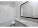 Clean bathroom featuring a tub with a shower and granite countertop vanity at 2644 S Dock St, Gilbert, AZ 85295