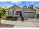 Charming single-Gathering home boasts a well-manicured front yard, stone accents, and a two-car garage at 2644 S Dock St, Gilbert, AZ 85295