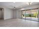 Open living area with tiled floors, a sliding glass door to the patio, and neutral wall paint at 2644 S Dock St, Gilbert, AZ 85295