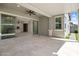 Covered patio featuring tile flooring, ceiling fan, and sliding glass doors that open to the home's interior at 2644 S Dock St, Gilbert, AZ 85295
