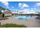 Community pool area featuring palm trees, lounge chairs and shaded areas at 2644 S Dock St, Gilbert, AZ 85295