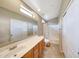 Bright bathroom with a double sink vanity, a large mirror, and a shower over tub at 2725 E Mine Creek Rd # 2058, Phoenix, AZ 85024