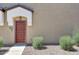 Tan home exterior with a decorative security door and low-maintenance desert landscaping at 2725 E Mine Creek Rd # 2058, Phoenix, AZ 85024