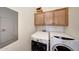 Convenient laundry area featuring a washer and dryer with storage cabinets at 2725 E Mine Creek Rd # 2058, Phoenix, AZ 85024