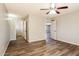 An empty bedroom showcases hardwood floors and a ceiling fan, with doorways leading to other rooms at 3045 W Palmaire Ave, Phoenix, AZ 85051