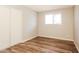 This neutral bedroom offers hardwood floors, a window, and a built-in closet at 3045 W Palmaire Ave, Phoenix, AZ 85051