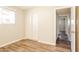 Bedroom with hardwood flooring, a window, and a closet, with a view into the hall at 3045 W Palmaire Ave, Phoenix, AZ 85051