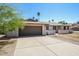 Spacious driveway leading to a two-car garage, complemented by a well-maintained exterior at 3045 W Palmaire Ave, Phoenix, AZ 85051