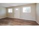 Bright living room with new laminate flooring and natural light from two windows at 3045 W Palmaire Ave, Phoenix, AZ 85051