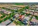 Aerial view of home showcases backyard pool, verdant lawn, and neighborhood with a green field nearby at 3072 E Appaloosa Rd, Gilbert, AZ 85296