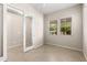 Versatile bedroom with tile flooring, large windows with blinds, and an adjoining door at 3072 E Appaloosa Rd, Gilbert, AZ 85296