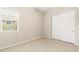 Bright bedroom features tile flooring, a large window, and a closet with white sliding doors at 3072 E Appaloosa Rd, Gilbert, AZ 85296
