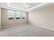 Spacious bedroom with carpet flooring, tray ceiling, ceiling fan and three windows at 3072 E Appaloosa Rd, Gilbert, AZ 85296
