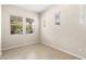 Cozy bedroom with tile flooring and three windows offering pleasant views of the neighborhood at 3072 E Appaloosa Rd, Gilbert, AZ 85296