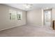 Upstairs bedroom with plush carpeting, a ceiling fan, and two windows offering ample natural light at 3072 E Appaloosa Rd, Gilbert, AZ 85296