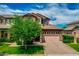 Charming two-story home featuring manicured front yard and a two car garage with a brick driveway at 3072 E Appaloosa Rd, Gilbert, AZ 85296
