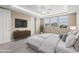 Modern main bedroom featuring a king-size bed, a dresser, and a ceiling fan at 3072 E Appaloosa Rd, Gilbert, AZ 85296