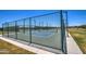 A view of pickleball courts, fenced and lit, with manicured green grass and desert landscaping at 3072 E Appaloosa Rd, Gilbert, AZ 85296