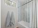 Modern bathroom showcasing a bathtub with patterned tiles, towels, and a window for natural light at 3114 S Eugene --, Mesa, AZ 85212