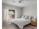 Bright bedroom featuring a ceiling fan, a window with sheer curtains, and a comfortable-looking bed at 3114 S Eugene --, Mesa, AZ 85212