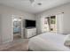 Serene bedroom with a flat screen TV, view to backyard, neutral tones, and access to ensuite bath at 3114 S Eugene --, Mesa, AZ 85212
