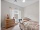 Cozy bedroom with a ceiling fan, a window for natural light, and cherry blossom painted on wall at 3114 S Eugene --, Mesa, AZ 85212