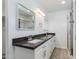 Bathroom features dual sinks with dark countertops, white cabinets, and a glass shower door at 3601 N 12Th St, Phoenix, AZ 85014