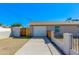 Home's garage, driveway, fencing, and minimalist desert landscaping at 3601 N 12Th St, Phoenix, AZ 85014