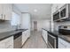 Modern kitchen with white cabinets, stainless steel appliances, and a gray subway tile backsplash at 3601 N 12Th St, Phoenix, AZ 85014