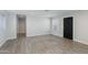 Spacious living room with wood-look tile floors, neutral walls, and modern lighting at 3601 N 12Th St, Phoenix, AZ 85014