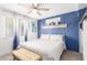 Cozy bedroom with a comfortable bed, stylish accent wall, and soft natural lighting at 3645 N 69Th Ave # 12, Phoenix, AZ 85033