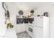 Efficient kitchen space with white appliances, decorative backsplash, and patterned floors at 3645 N 69Th Ave # 12, Phoenix, AZ 85033