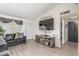 Inviting living room with a modern TV, comfortable seating, and bright natural light at 3645 N 69Th Ave # 12, Phoenix, AZ 85033