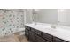 Bathroom featuring double sinks, neutral walls, and a shower with a decorative shower curtain at 514 E Pearce Rd, Phoenix, AZ 85042