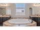 Bathroom with a large soaking tub, granite countertops, and and vanities at 514 E Pearce Rd, Phoenix, AZ 85042