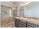 Bathroom featuring a walk-in shower with neutral toned tile and updated vanity at 514 E Pearce Rd, Phoenix, AZ 85042