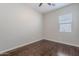 Bedroom featuring wood floors, neutral colored walls, and a window with wood blinds at 514 E Pearce Rd, Phoenix, AZ 85042
