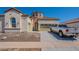 Exterior elevation of home showcasing a beige stucco finish, terracotta roof, two-car garage, and a circular tower at 514 E Pearce Rd, Phoenix, AZ 85042