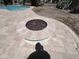 Outdoor patio with travertine pavers and a modern fire pit, ideal for entertaining at 514 E Pearce Rd, Phoenix, AZ 85042