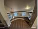 Balcony foyer featuring decorative railing and wood floors glimpsed below, blending architectural detail with open space at 514 E Pearce Rd, Phoenix, AZ 85042
