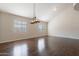 Living room featuring hardwood floors, neutral paint, vaulted ceiling, and windows with backyard views at 514 E Pearce Rd, Phoenix, AZ 85042