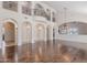 Spacious living room featuring dark wood floors, high ceilings, arched doorways, and a wrought iron balcony at 514 E Pearce Rd, Phoenix, AZ 85042