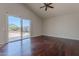 Living room featuring hardwood floors, neutral paint, vaulted ceiling, and a sliding glass door to the patio at 514 E Pearce Rd, Phoenix, AZ 85042