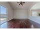 Living room featuring hardwood floors, neutral paint, vaulted ceilings, a view to the patio, and pass through to kitchen at 514 E Pearce Rd, Phoenix, AZ 85042