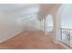 Spacious loft area featuring neutral walls, carpet, and a decorative wrought iron railing at 514 E Pearce Rd, Phoenix, AZ 85042