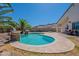 A freeform pool surrounded by decorative pavers, stone planters, and a lush lawn at 514 E Pearce Rd, Phoenix, AZ 85042